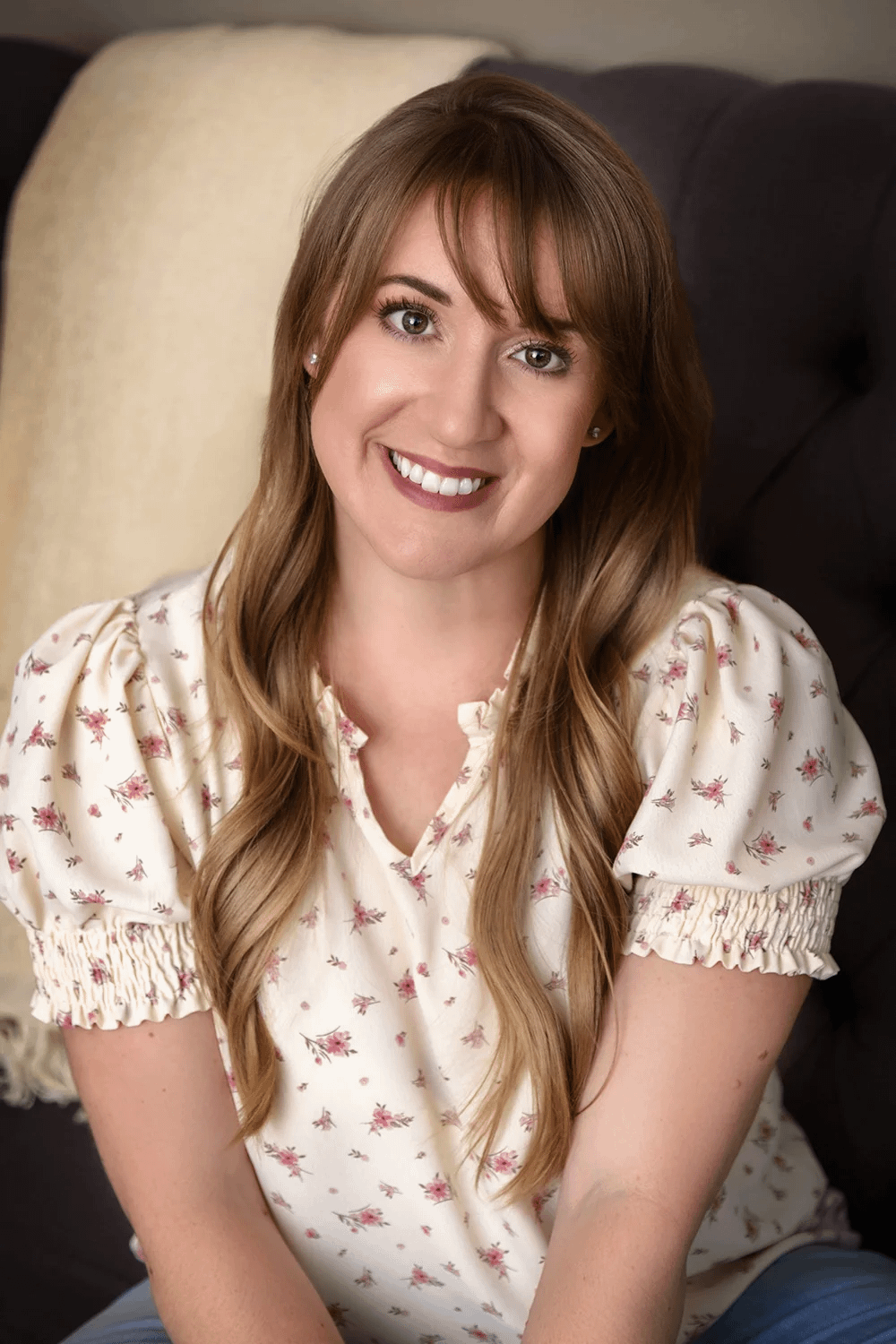 Professional headshot of wedding photographer Breiann smiling at Masterpiece Images studio