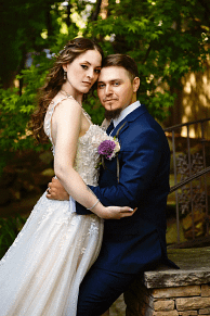 Outdoor bride and groom portrait during a summer wedding by Masterpiece Images