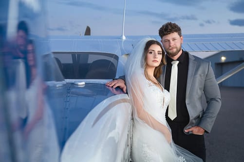 Cinematic outdoor wedding portrait of bride and groom with mountain view